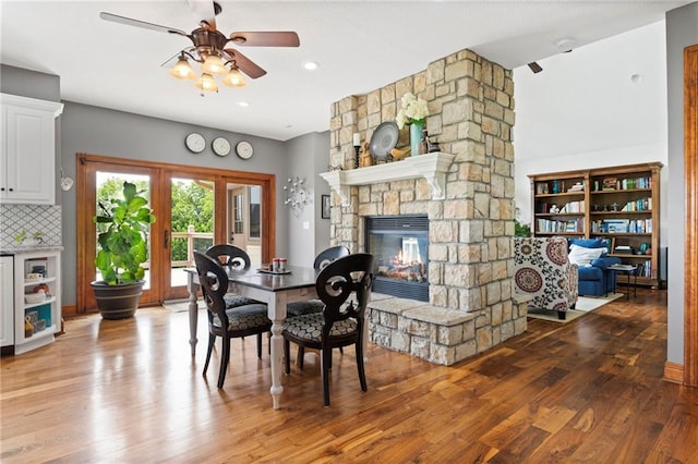 15405 161st St, Bonner Springs, KS 66012 - dining space featuring a ceiling fan, light wood-type flooring, and a fireplace