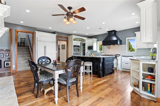15405 161st St, Bonner Springs, KS 66012 - dining room with a ceiling fan, stairway, light wood-style floors, and recessed lighting
