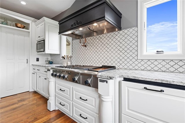 15405 161st St, Bonner Springs, KS 66012 - kitchen with custom exhaust hood, stainless steel appliances, decorative backsplash, and white cabinets