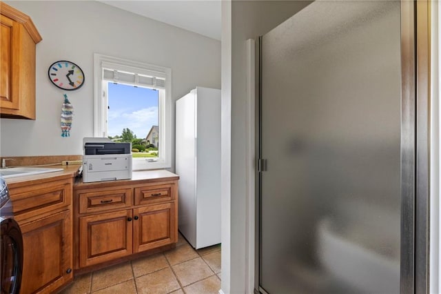 15405 161st St, Bonner Springs, KS 66012 - full bath featuring vanity, a stall shower, tile patterned floors, and washer / dryer