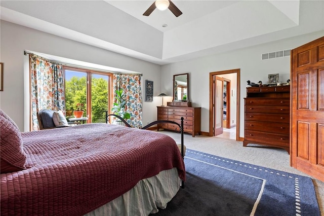 15405 161st St, Bonner Springs, KS 66012 - bedroom with carpet floors, multiple windows, a tray ceiling, and a ceiling fan