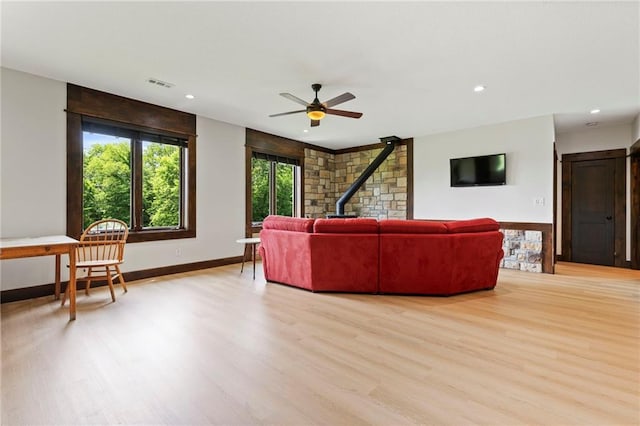 15405 161st St, Bonner Springs, KS 66012 - living area featuring a wood stove, light wood-type flooring, ceiling fan, and recessed lighting