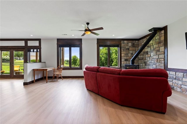 15405 161st St, Bonner Springs, KS 66012 - living area with a wood stove, wood finished floors, ceiling fan, healthy amount of natural light, and recessed lighting