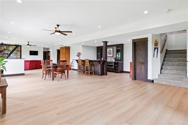 15405 161st St, Bonner Springs, KS 66012 - dining area featuring stairway, light wood-type flooring, recessed lighting, bar area, and ceiling fan