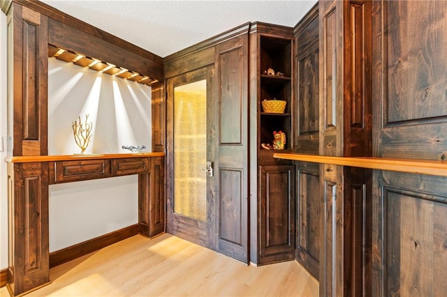 15405 161st St, Bonner Springs, KS 66012 - wine area with light wood-style flooring and a textured ceiling