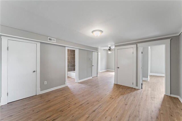 115 Brown Ave, Osawatomie, KS 66064 - unfurnished living room featuring light wood-style floors, ceiling fan, and baseboards