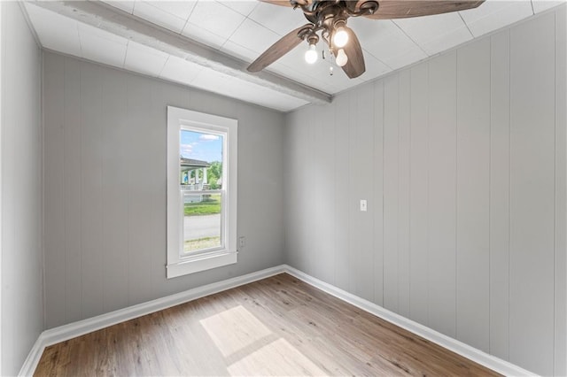 115 Brown Ave, Osawatomie, KS 66064 - spare room with wood finished floors, beamed ceiling, baseboards, and ceiling fan