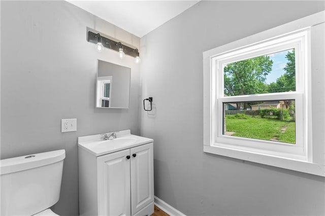 115 Brown Ave, Osawatomie, KS 66064 - bathroom featuring toilet, vanity, and baseboards