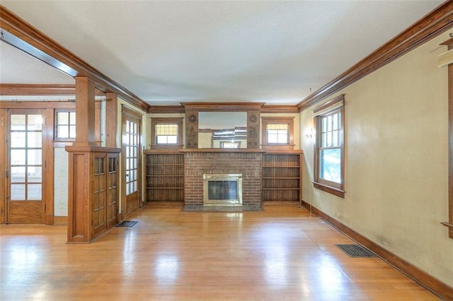 12 W 57th Ter, Kansas City, MO 64113 - unfurnished living room with ornamental molding, wood finished floors, a fireplace, and french doors