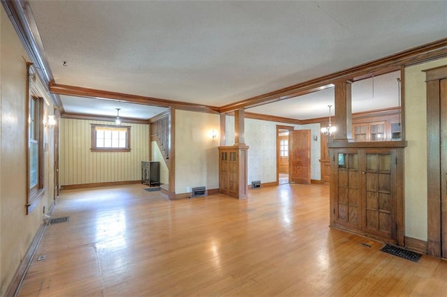 12 W 57th Ter, Kansas City, MO 64113 - unfurnished living room featuring ornamental molding and light wood finished floors