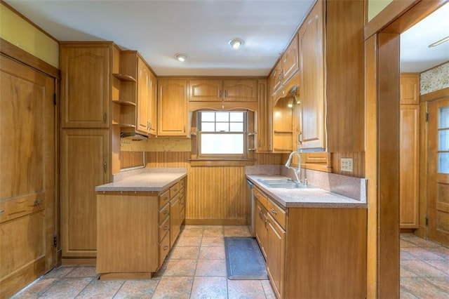 12 W 57th Ter, Kansas City, MO 64113 - kitchen with light countertops, stone tile floors, brown cabinetry, open shelves, and wooden walls