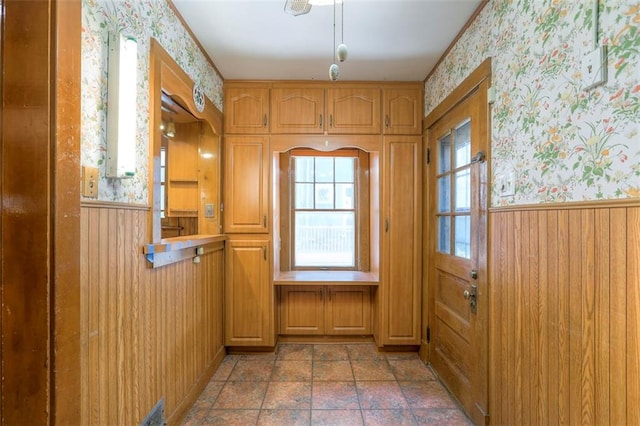 12 W 57th Ter, Kansas City, MO 64113 - doorway to outside featuring wallpapered walls, wainscoting, and wood walls