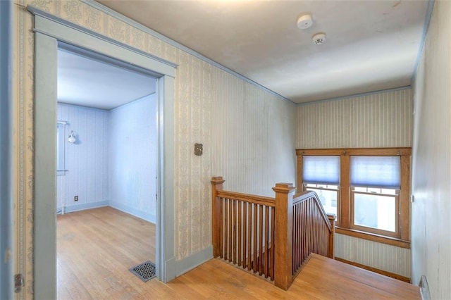 12 W 57th Ter, Kansas City, MO 64113 - hallway featuring wood finished floors, an upstairs landing, and wallpapered walls