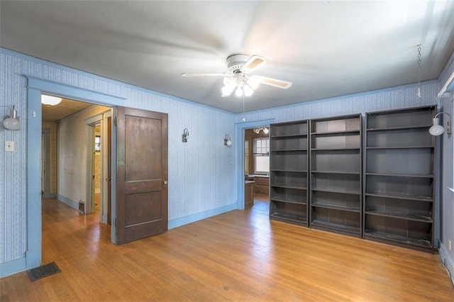 12 W 57th Ter, Kansas City, MO 64113 - unfurnished room with wood finished floors, a ceiling fan, and wallpapered walls