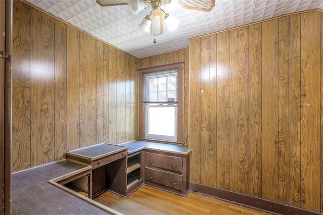 12 W 57th Ter, Kansas City, MO 64113 - unfurnished office with wood walls, wood finished floors, and a ceiling fan