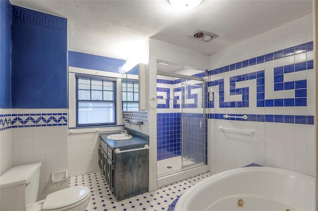 12 W 57th Ter, Kansas City, MO 64113 - full bath featuring tile walls, a stall shower, vanity, a textured ceiling, and a whirlpool tub