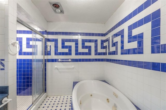 12 W 57th Ter, Kansas City, MO 64113 - bathroom featuring a shower stall, a tub with jets, tile walls, and a textured ceiling