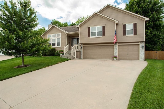 3223 SW Amber Ct, Lees Summit, MO 64082 - tri-level home with a garage, concrete driveway, and a chimney