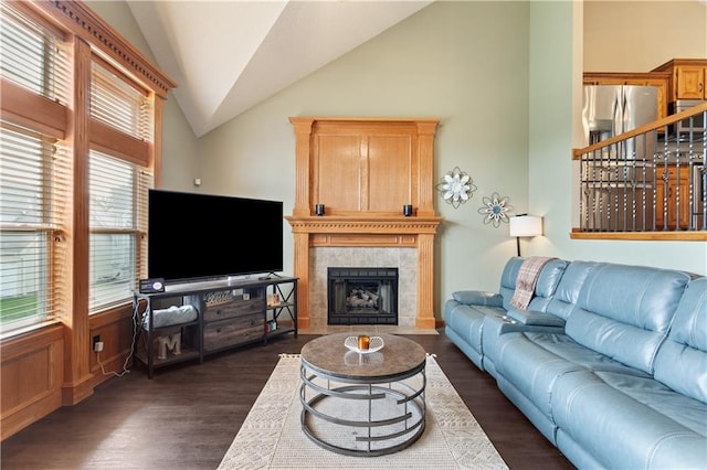 3223 SW Amber Ct, Lees Summit, MO 64082 - living room featuring vaulted ceiling, dark wood-type flooring, and a tiled fireplace