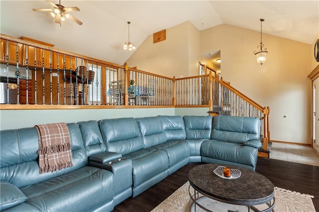 3223 SW Amber Ct, Lees Summit, MO 64082 - living room featuring wood finished floors, ceiling fan, stairway, high vaulted ceiling, and baseboards