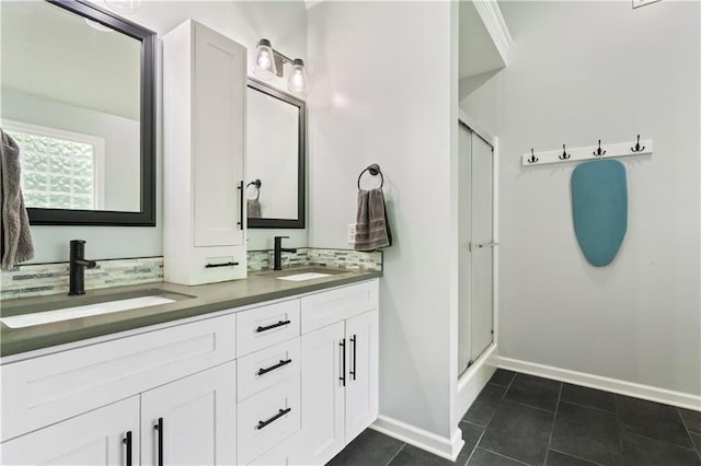 3223 SW Amber Ct, Lees Summit, MO 64082 - full bathroom with a stall shower, double vanity, baseboards, and tile patterned floors