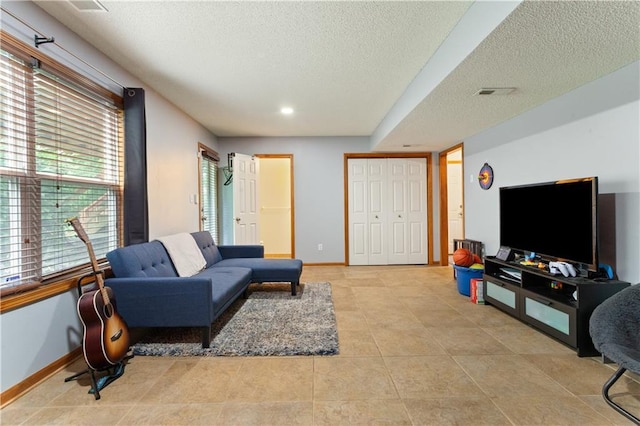 3223 SW Amber Ct, Lees Summit, MO 64082 - living area with a textured ceiling, baseboards, light tile patterned floors, and recessed lighting