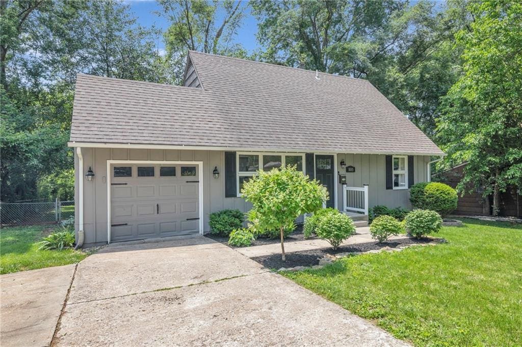 8005 W 91st St, Overland Park, KS 66212 - view of front of house featuring roof with shingles, a garage, and driveway