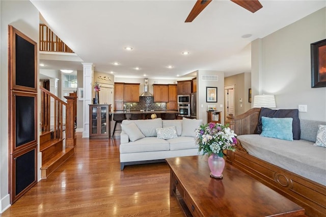 22404 S Roosevelt St, Spring Hill, KS 66083 - living room featuring wood finished floors, stairway, ceiling fan, recessed lighting, and decorative columns