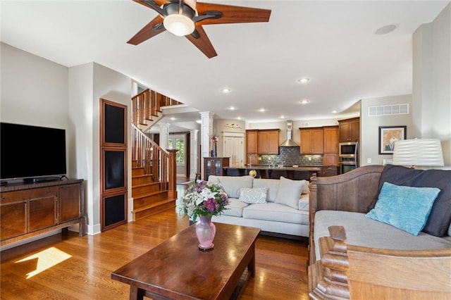 22404 S Roosevelt St, Spring Hill, KS 66083 - living room featuring a ceiling fan, ornate columns, wood finished floors, stairway, and recessed lighting