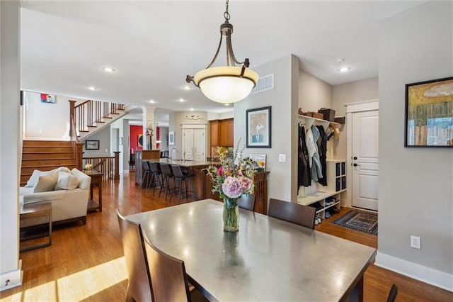 22404 S Roosevelt St, Spring Hill, KS 66083 - dining room featuring dark wood-type flooring, stairs, baseboards, ornate columns, and recessed lighting