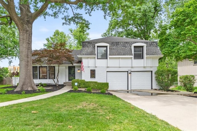 5000 W 96th St, Overland Park, KS 66207 - view of front of home featuring roof with shingles, an attached garage, brick siding, a front yard, and concrete driveway