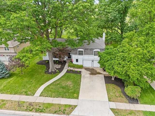5000 W 96th St, Overland Park, KS 66207 - view of front of house featuring driveway, roof with shingles, and a front yard
