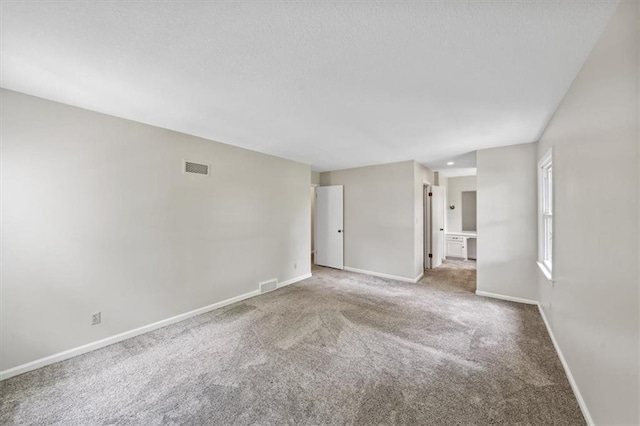 5000 W 96th St, Overland Park, KS 66207 - carpeted empty room featuring baseboards and a textured ceiling