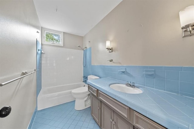 5000 W 96th St, Overland Park, KS 66207 - full bathroom with tile patterned flooring, toilet, washtub / shower combination, vanity, and tile walls