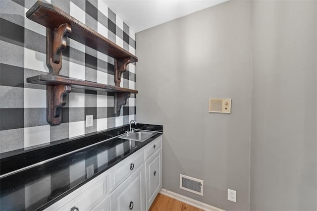5000 W 96th St, Overland Park, KS 66207 - kitchen featuring open shelves, a sink, white cabinets, light wood-style flooring, and decorative backsplash