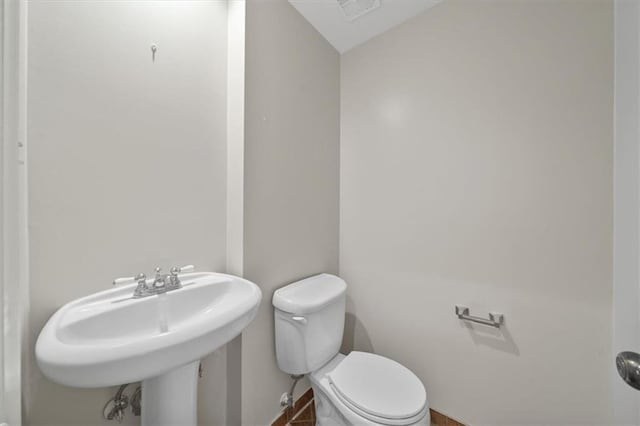 5000 W 96th St, Overland Park, KS 66207 - half bathroom with toilet, baseboards, and a sink