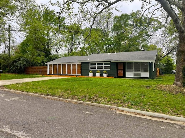 1704 W 20th St, Lawrence, KS 66046 - ranch-style home featuring a sunroom, a front yard, and driveway