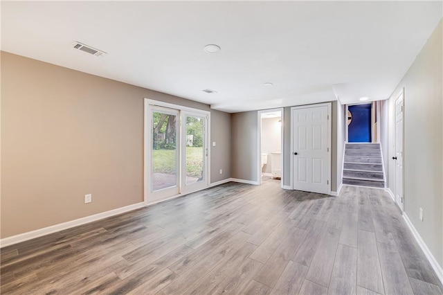 5912 E 98th St, Kansas City, MO 64134 - unfurnished room with wood finished floors, stairs, and baseboards