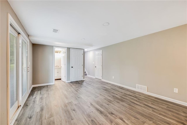 5912 E 98th St, Kansas City, MO 64134 - unfurnished bedroom with light wood-style floors, baseboards, and connected bathroom