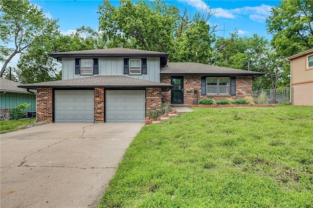 5912 E 98th St, Kansas City, MO 64134 - tri-level home with concrete driveway, brick siding, board and batten siding, and a garage