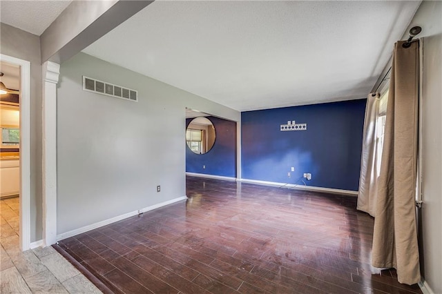 5912 E 98th St, Kansas City, MO 64134 - unfurnished room with baseboards, wood finished floors, and healthy amount of natural light