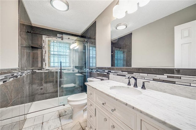 5912 E 98th St, Kansas City, MO 64134 - full bathroom featuring tile walls, vanity, a textured ceiling, a stall shower, and toilet