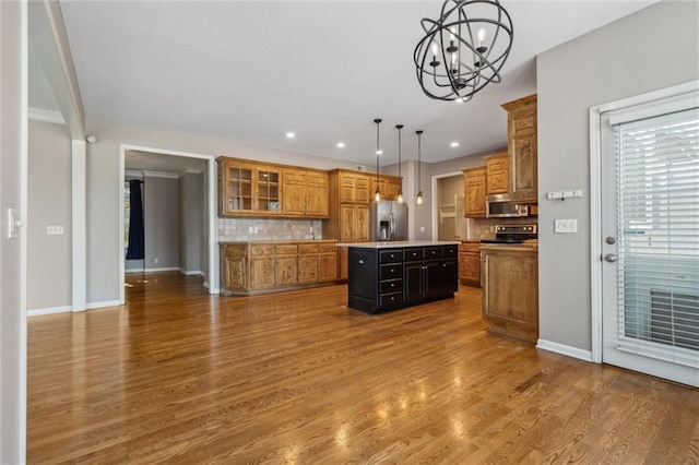 4528 N 108th St, Kansas City, KS 66109 - kitchen featuring stainless steel fridge with ice dispenser, a chandelier, ventilation hood, brown cabinets, and a kitchen island