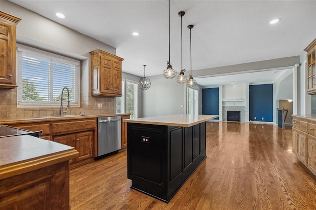 4528 N 108th St, Kansas City, KS 66109 - kitchen featuring stainless steel dishwasher, a sink, wood finished floors, a kitchen island, and recessed lighting