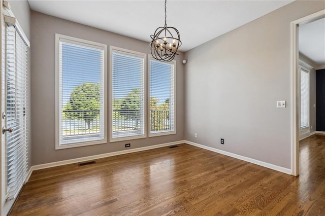 4528 N 108th St, Kansas City, KS 66109 - unfurnished dining area with a chandelier, wood finished floors, and baseboards