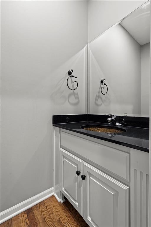 4528 N 108th St, Kansas City, KS 66109 - bathroom with vanity, wood finished floors, and baseboards