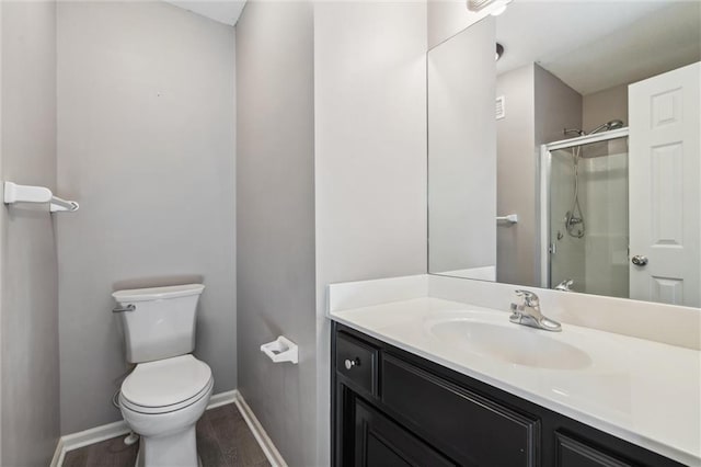 4528 N 108th St, Kansas City, KS 66109 - bathroom with toilet, a shower stall, vanity, baseboards, and wood finished floors