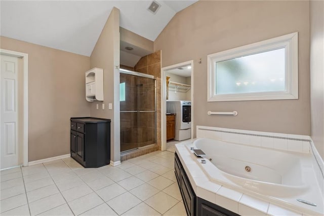 4528 N 108th St, Kansas City, KS 66109 - full bath with washer / clothes dryer, vaulted ceiling, a stall shower, a tub with jets, and tile patterned flooring