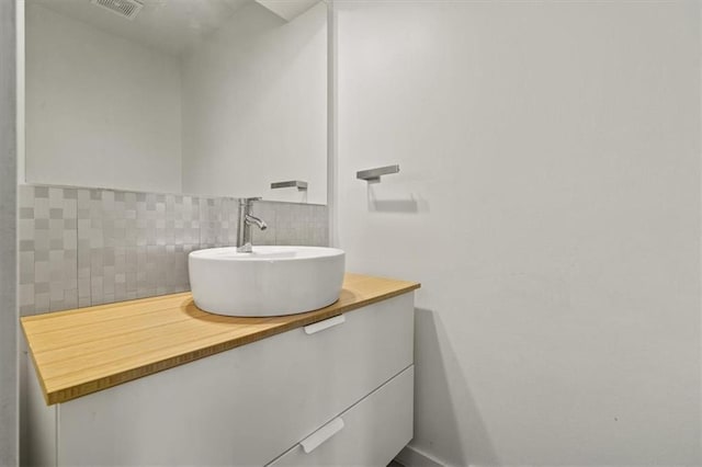 1038 N Woodland Ct, Oakwood, MO 64118 - bathroom featuring backsplash and vanity