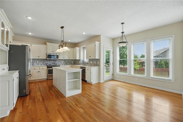 9729 Prairie Creek Rd, Lenexa, KS 66220 - kitchen with appliances with stainless steel finishes, open shelves, a textured ceiling, decorative backsplash, and white cabinets